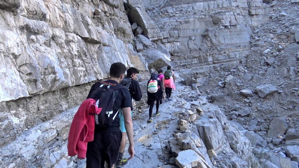 People walking along a mountain path