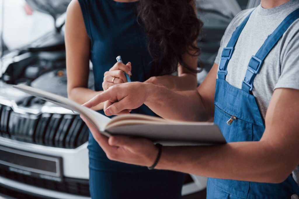 Close up of woman in the auto salon with employee